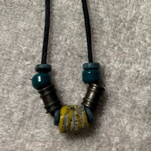 Turquoise & yellow beaded satin rope necklace. Overall length is 28”.